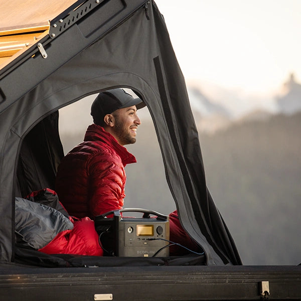Michael from Conquest Overland in his iKamper while wearing the Dasche L3 Jacket from Beyond Clothing.