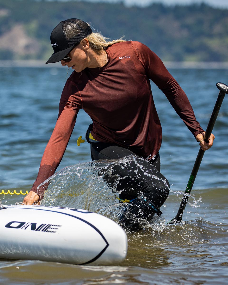 Women wearing the Geo-T Crew L.S. Shirt while paddle boarding. - Beyond Clothing USA