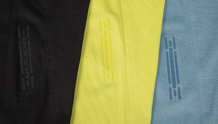 Lay down shot showing the laser cut ventilation holes on the Feathers Tech-Tank. Each color is shown from left to right: Black, Light Lime, Big Sky Blue.