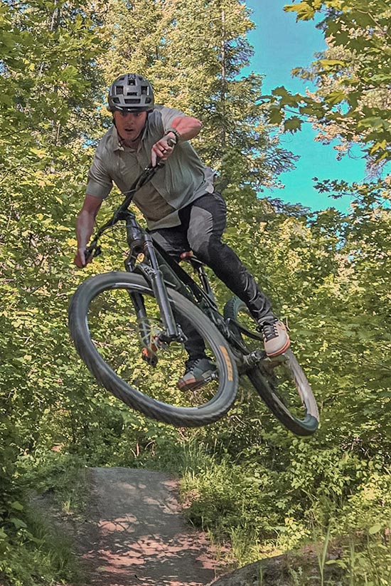 Mountain Biker wearing the Moonstone First Sun Shirt and Avid pants. 