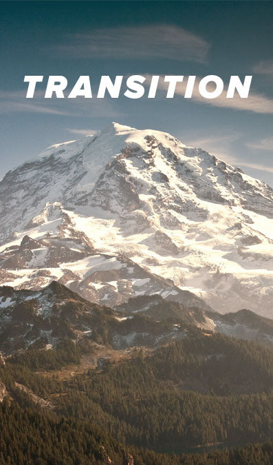 A majestic snow-covered mountain peak rises above a forested valley under a blue sky, with the word 'TRANSITION' in large white letters across the top. This is 2 of the 3 image collage of Mount Rainer.
