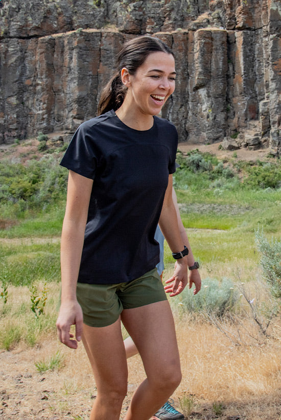 Woman model wearing the OlallieLoop Short and Feathers Tech-Tank. 