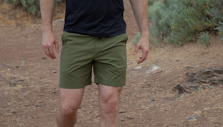 Man hiking in summer while wearing the Tarngood Short in Evergreen by Beyond Clothing. 