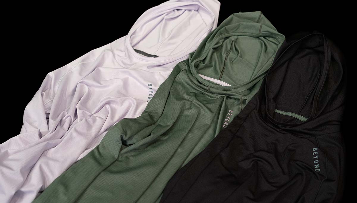 3 Colors of Womens Geo T Hooded LS Shirts laid down: Lilac Grey, Dark Mint and Black
